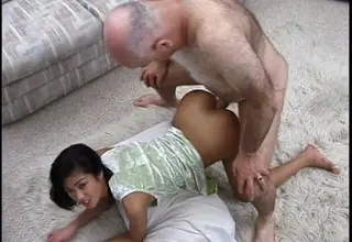 Grandpa enjoys this beauty's pierced pussy in a public setting. Their age difference adds an unusual dynamic to the open encounter.